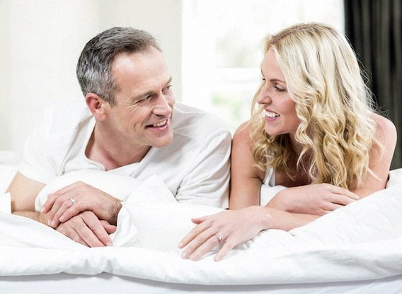 Man and woman talking in bed